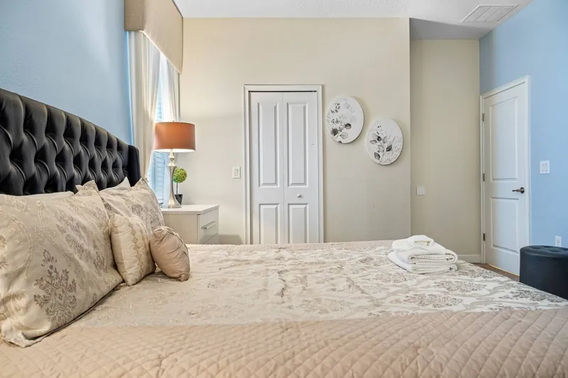 Another view of the tufted-headboard bedroom
